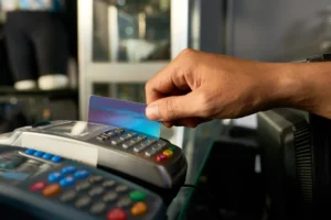 Customer using card reader at retail store counter