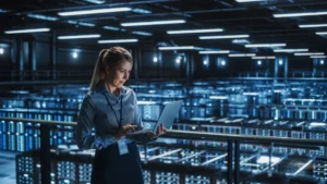 Person working on laptop in server room