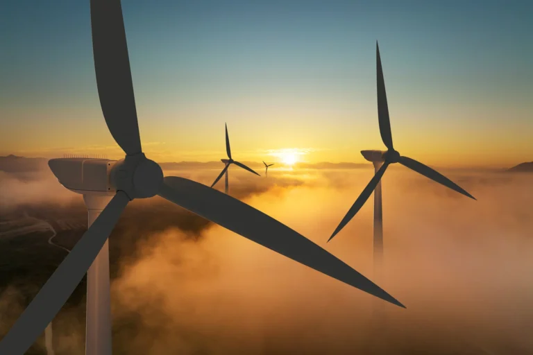 Wind turbines at sunrise representing reliable and scalable automated QA services and test automation solutions