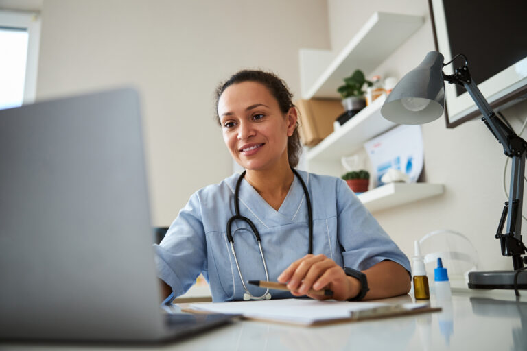NHS nurse using secure communications on laptop