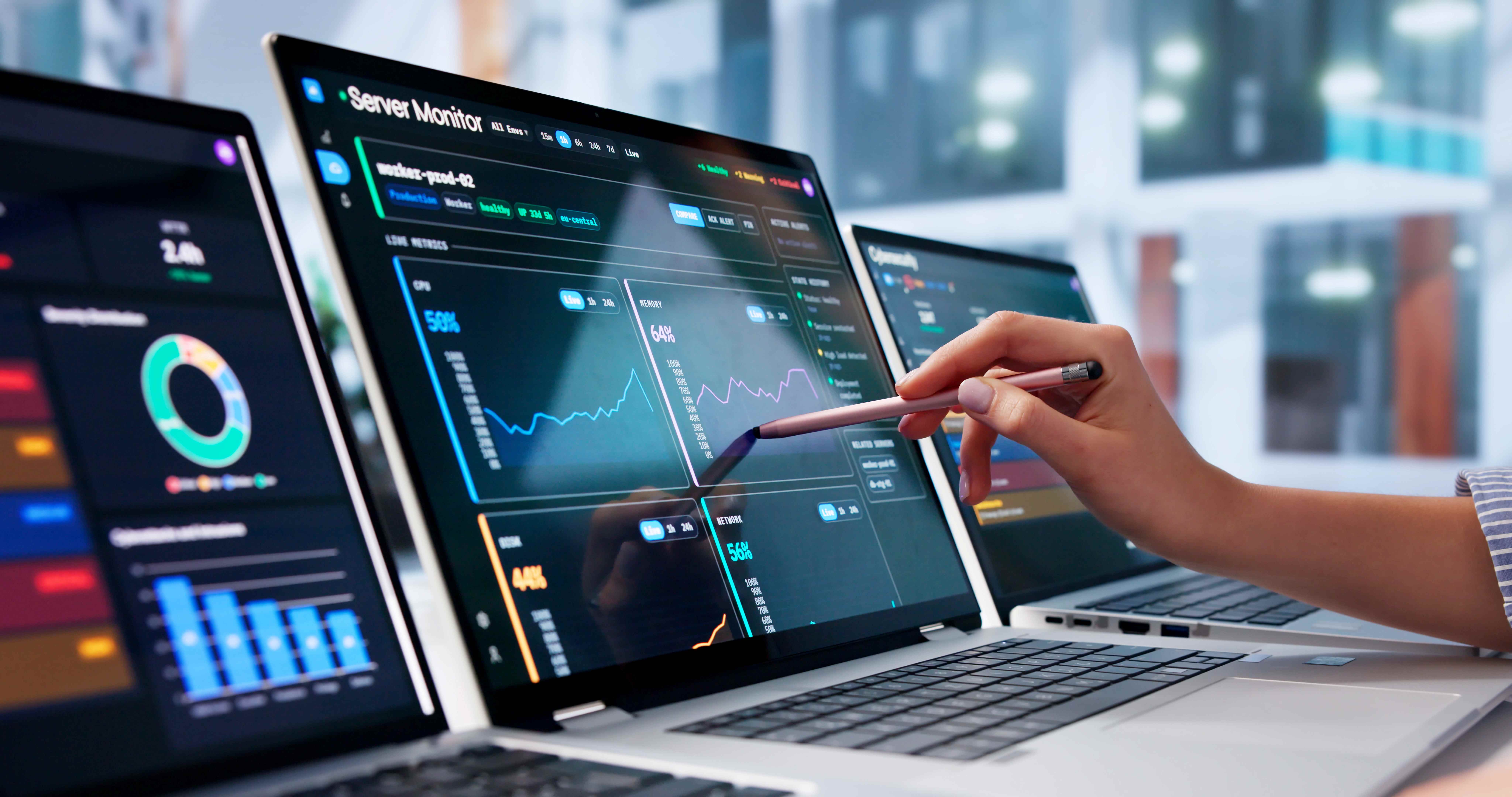 Person analyzing web app performance dashboards across multiple screens for responsive testing