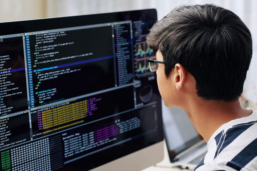 Developer writing HbbTV testing code and Ligada iSuite automation scripts