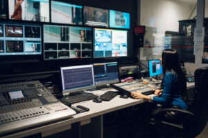 Engineer monitoring HbbTV broadcast streams and Ligada iSuite in control room