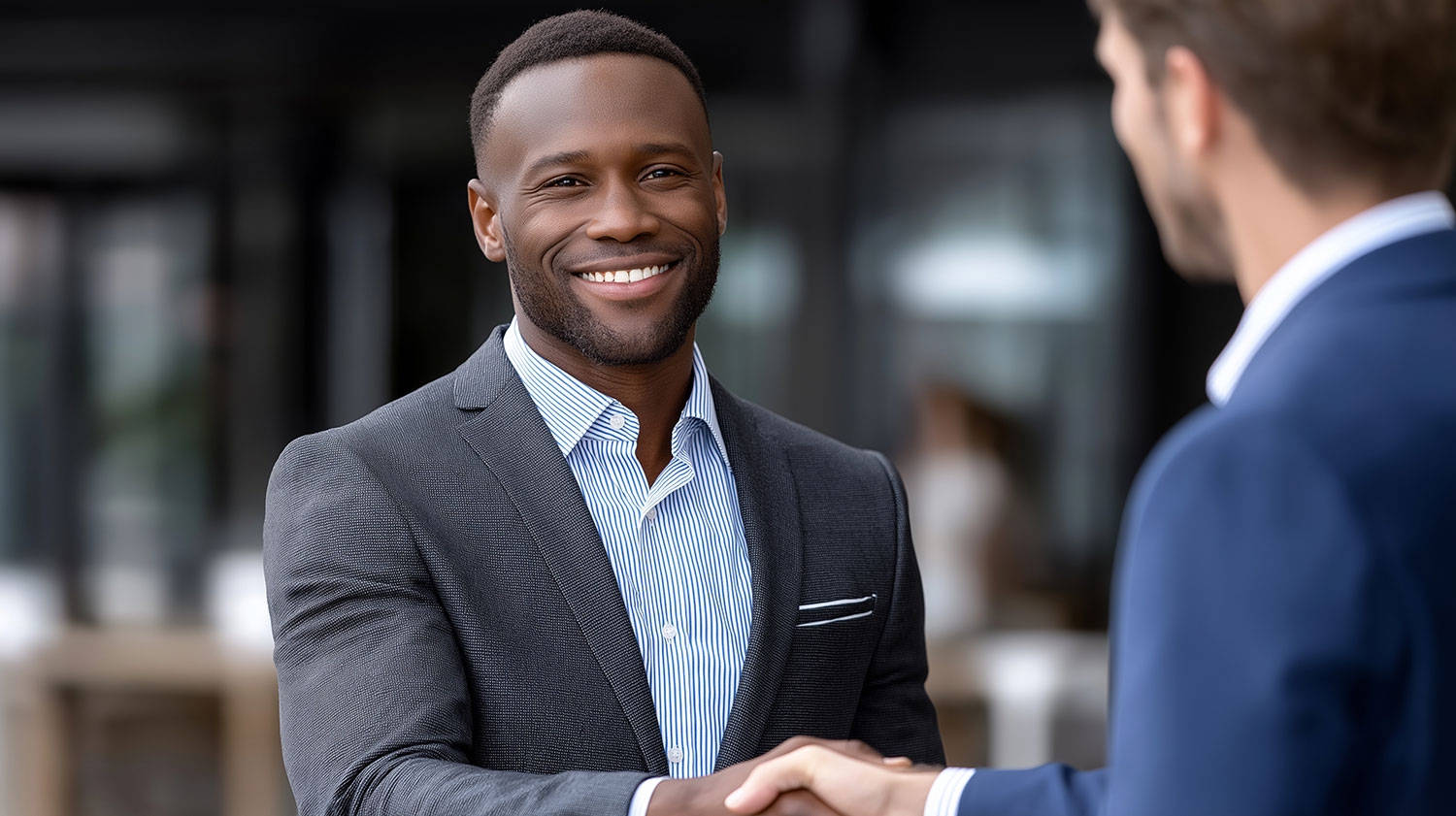 Two business professionals shaking hands in a professional setting