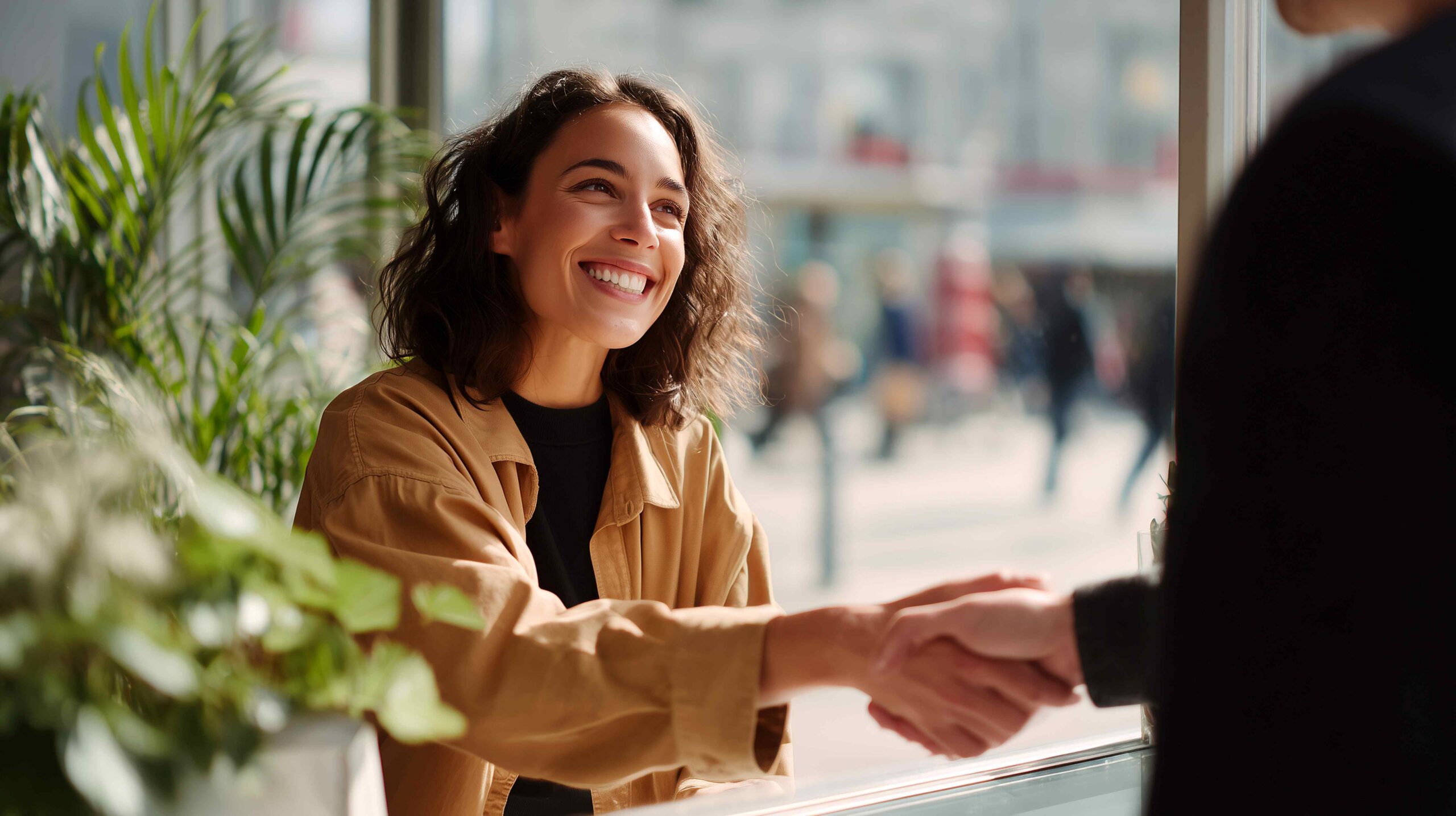 Woman shaking hands representing a reliable web and mobile app testing service partnership