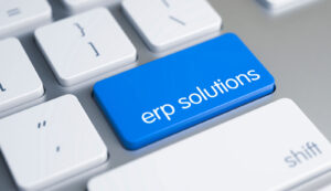 Keyboard with blue ERP solutions button highlighting enterprise resource planning