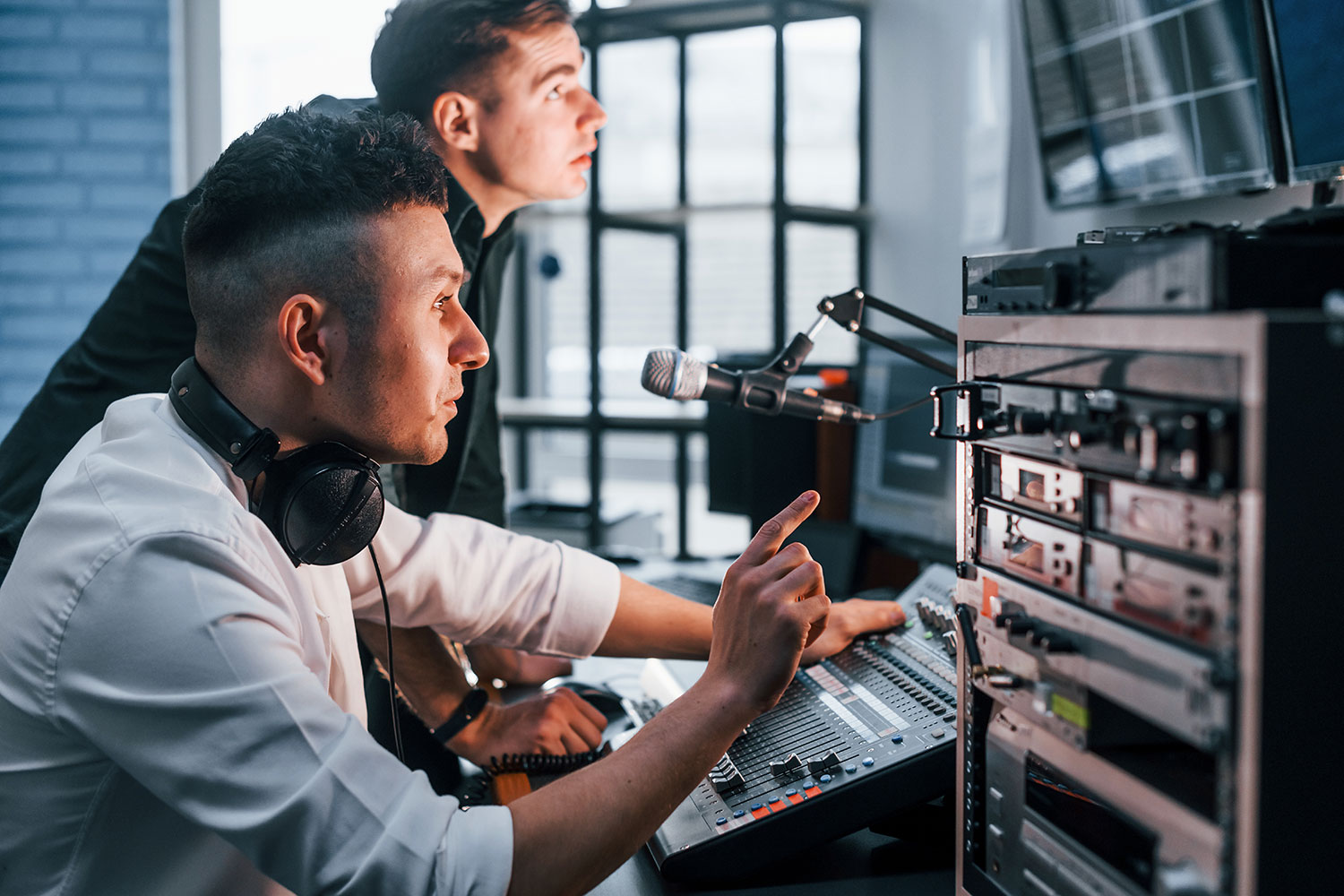 Engineers testing HbbTV broadcast equipment and Ligada iSuite solutions