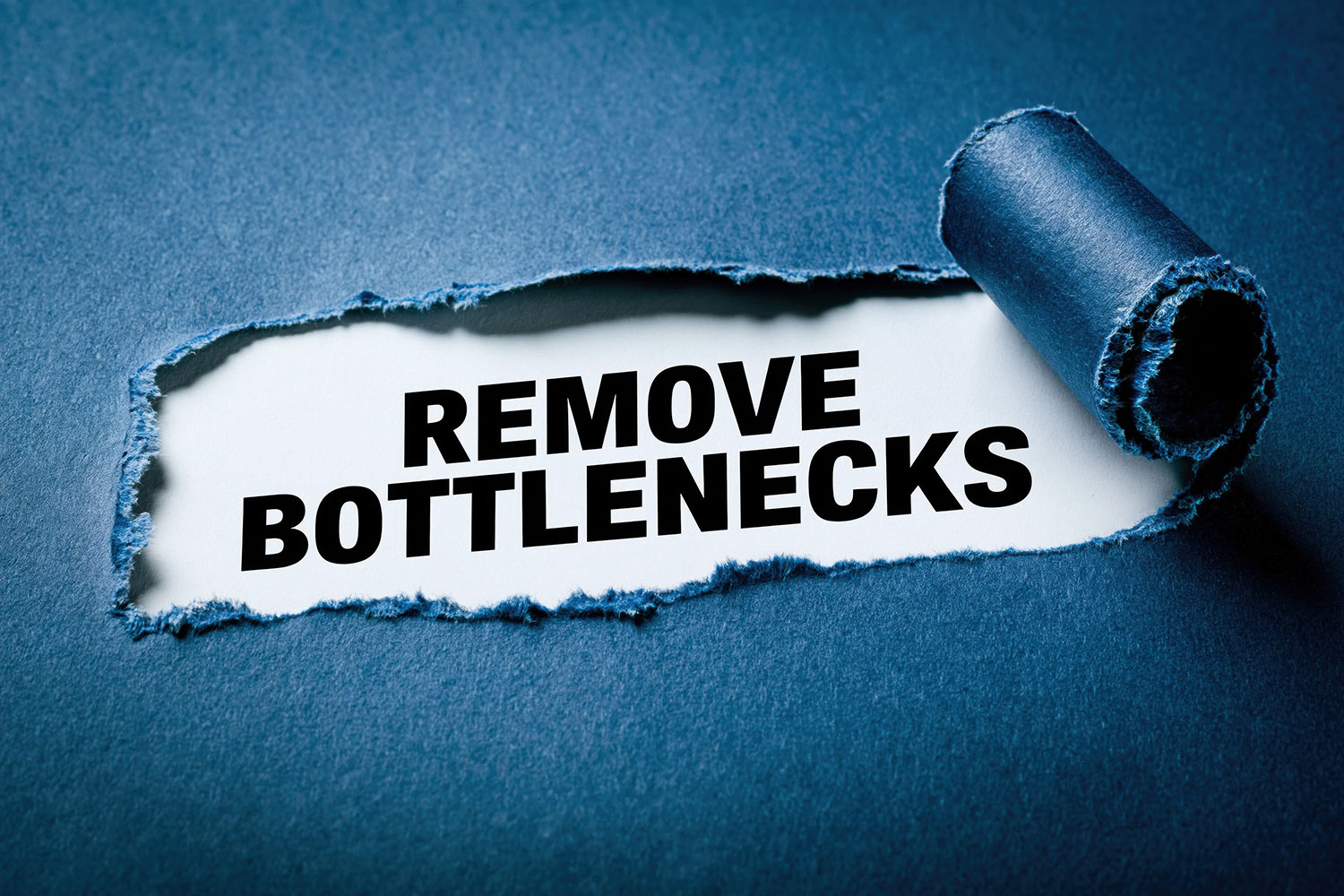 Torn paper revealing the text "Remove Bottlenecks" on a blue background