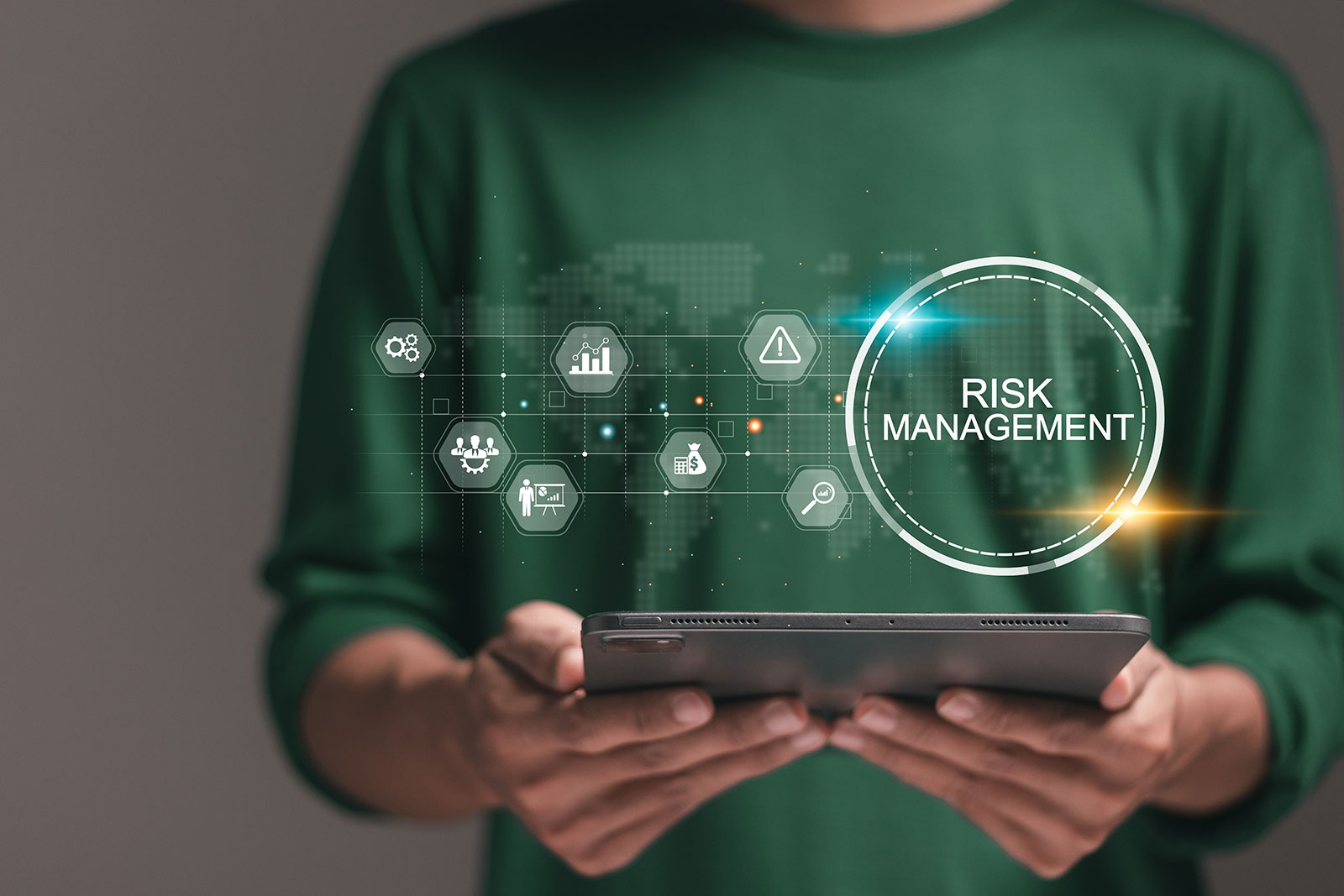 Person holding tablet with risk management icons representing digital accessibility and WCAG compliance testing