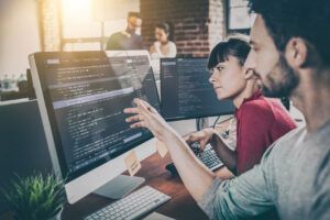 Developers collaborating on AI-driven software testing and digital assurance solutions
