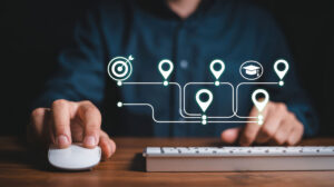 Person using a mouse with glowing location pin icons forming a digital journey map