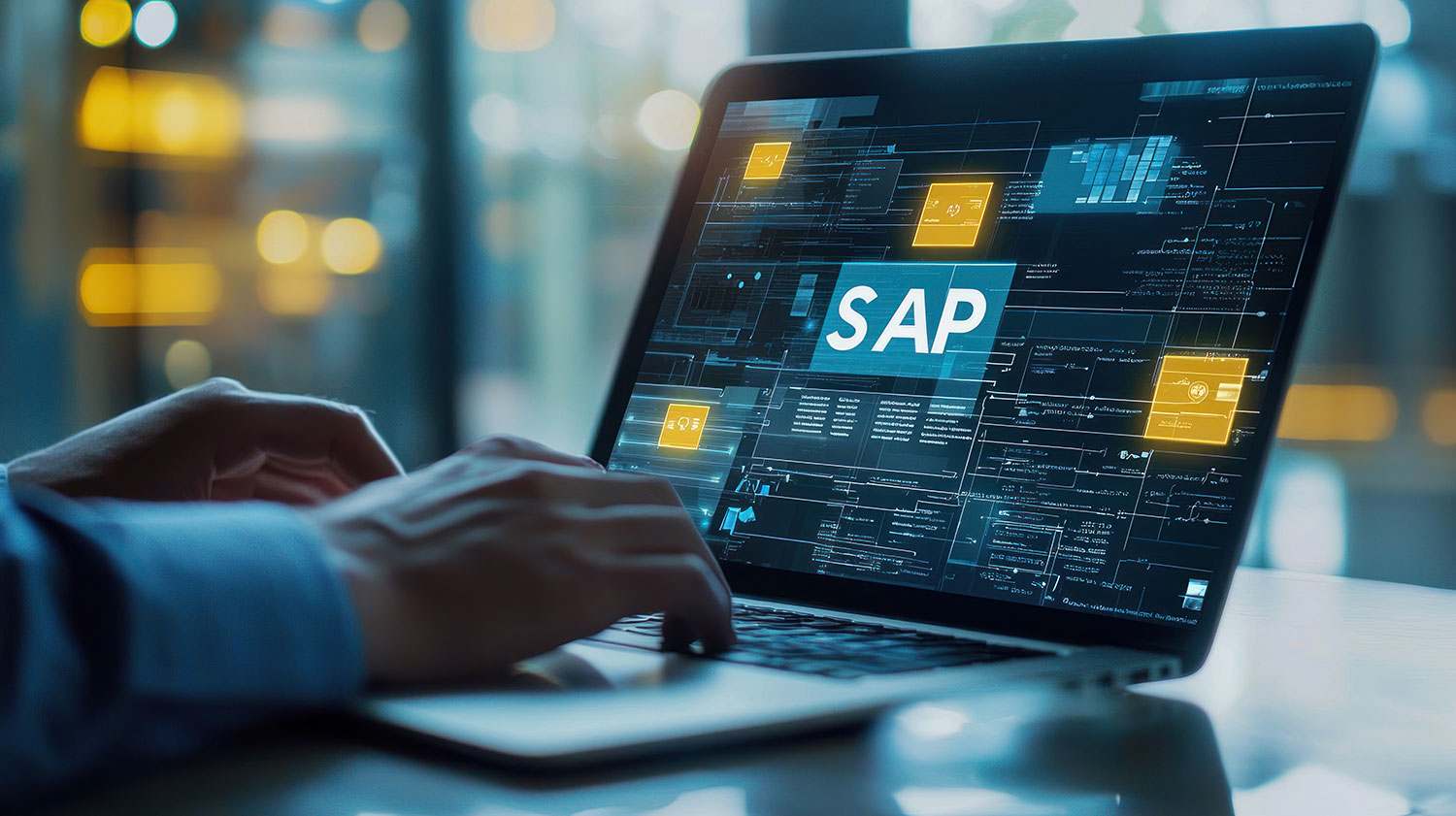 Hands typing on a laptop displaying a glowing SAP interface dashboard