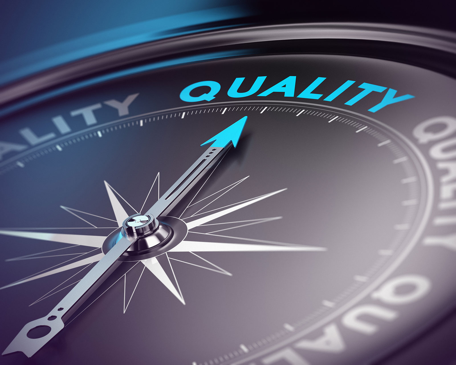Compass needle pointing towards the word quality on a dark dial