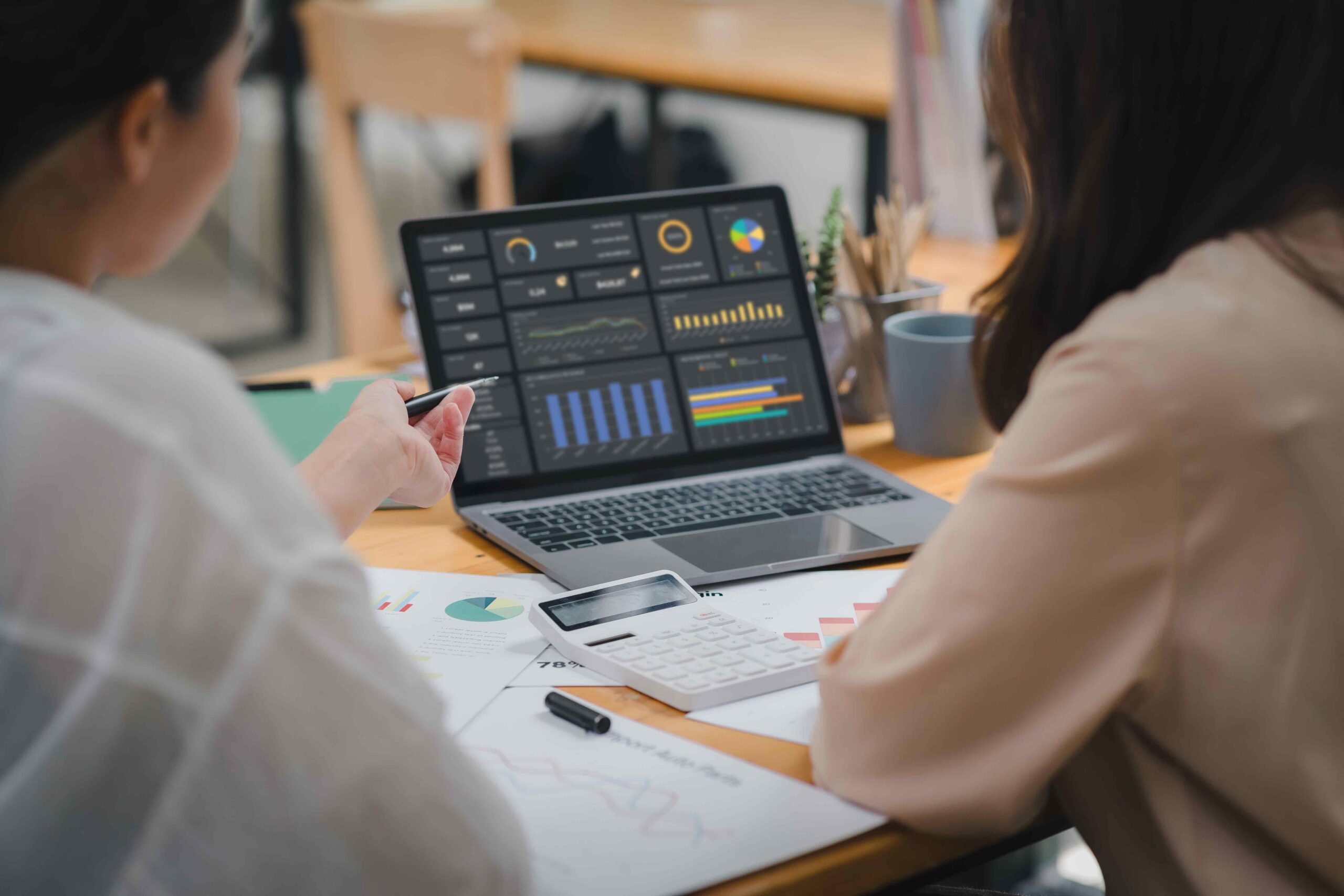 Women-checking-business-automation-statistics-on-computer