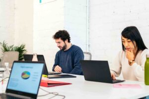 Coworkers collaborate on laptops in shared workspa 2026 03 24 07 49 19 utc
