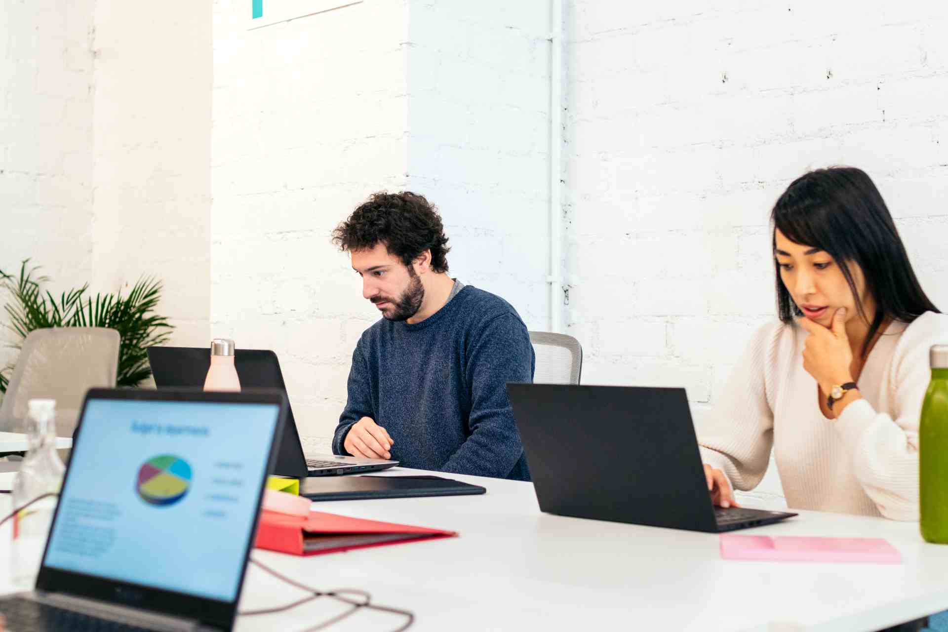 Coworkers collaborate on laptops in shared workspa 2026 03 24 07 49 19 utc