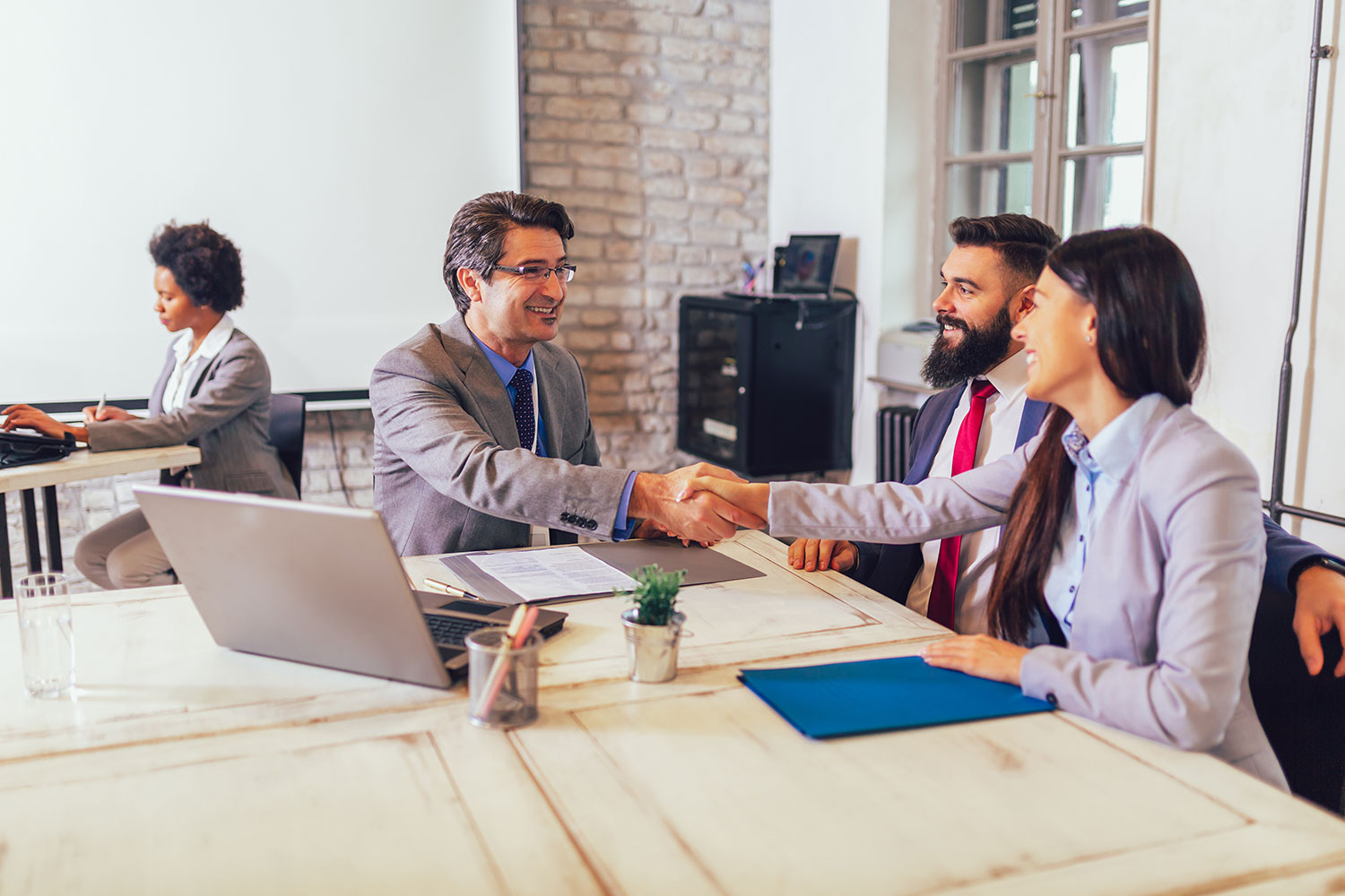 Business professionals shaking hands representing trusted cyber security testing partnership