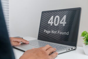 Laptop showing 404 error page highlighting the need for automated software testing services