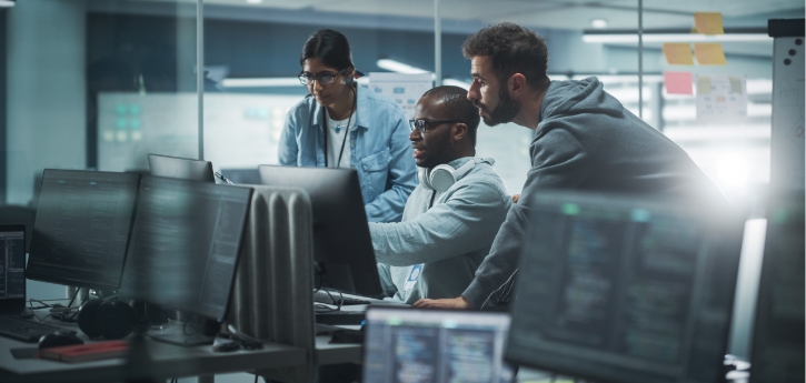 QA automation team collaborating on automated software testing solutions at workstations