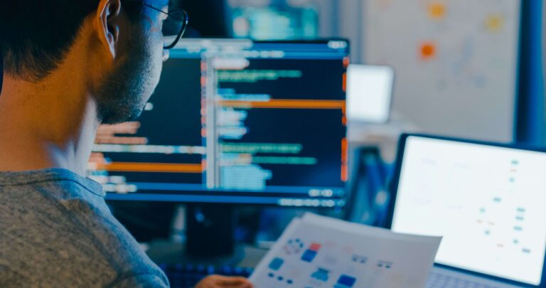 Software tester reviewing code and application workflows