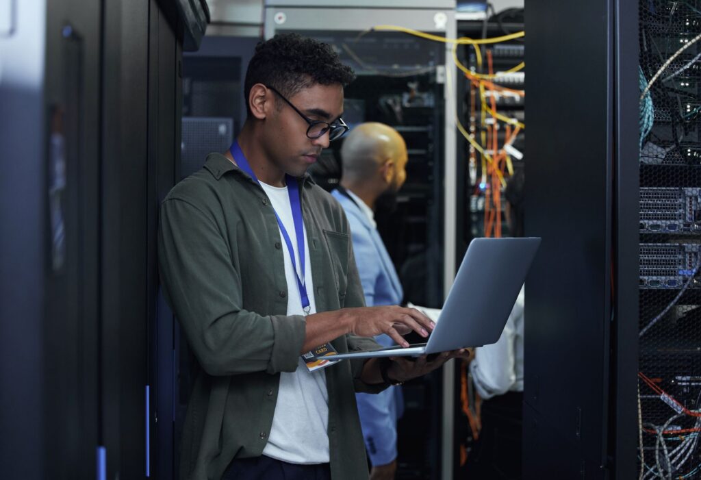 Engineer managing test infrastructure in a server room