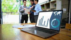 Business team reviewing AI performance testing and quality assurance analytics dashboard on laptop