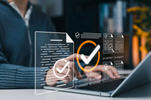 Person on a laptop with glowing digital document checkmarks and approval icons overlay