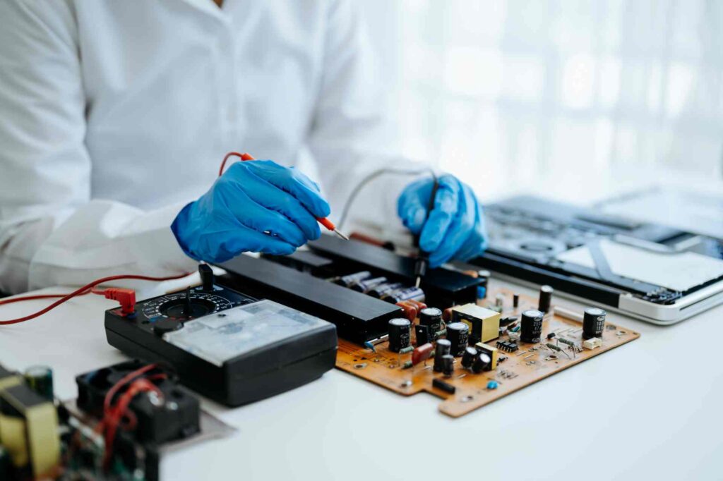 Technician repairing computer circuit board with m 2026 01 05 23 25 24 utc