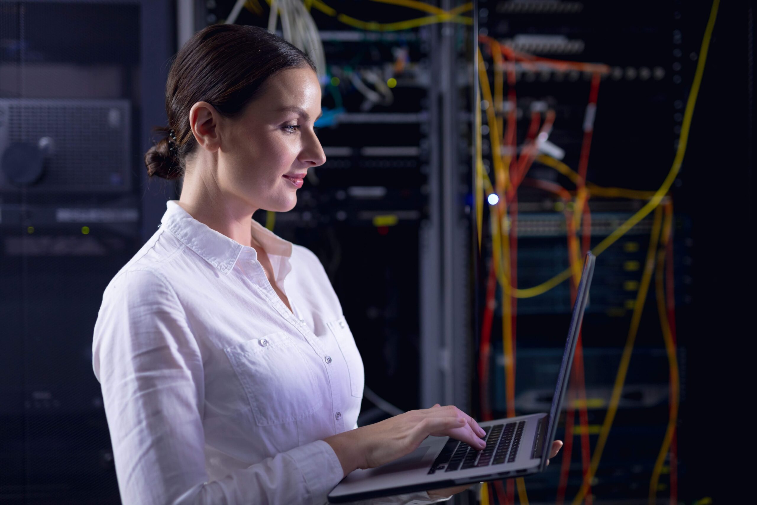 Technology professional monitoring software systems and network infrastructure using a laptop in a server environment