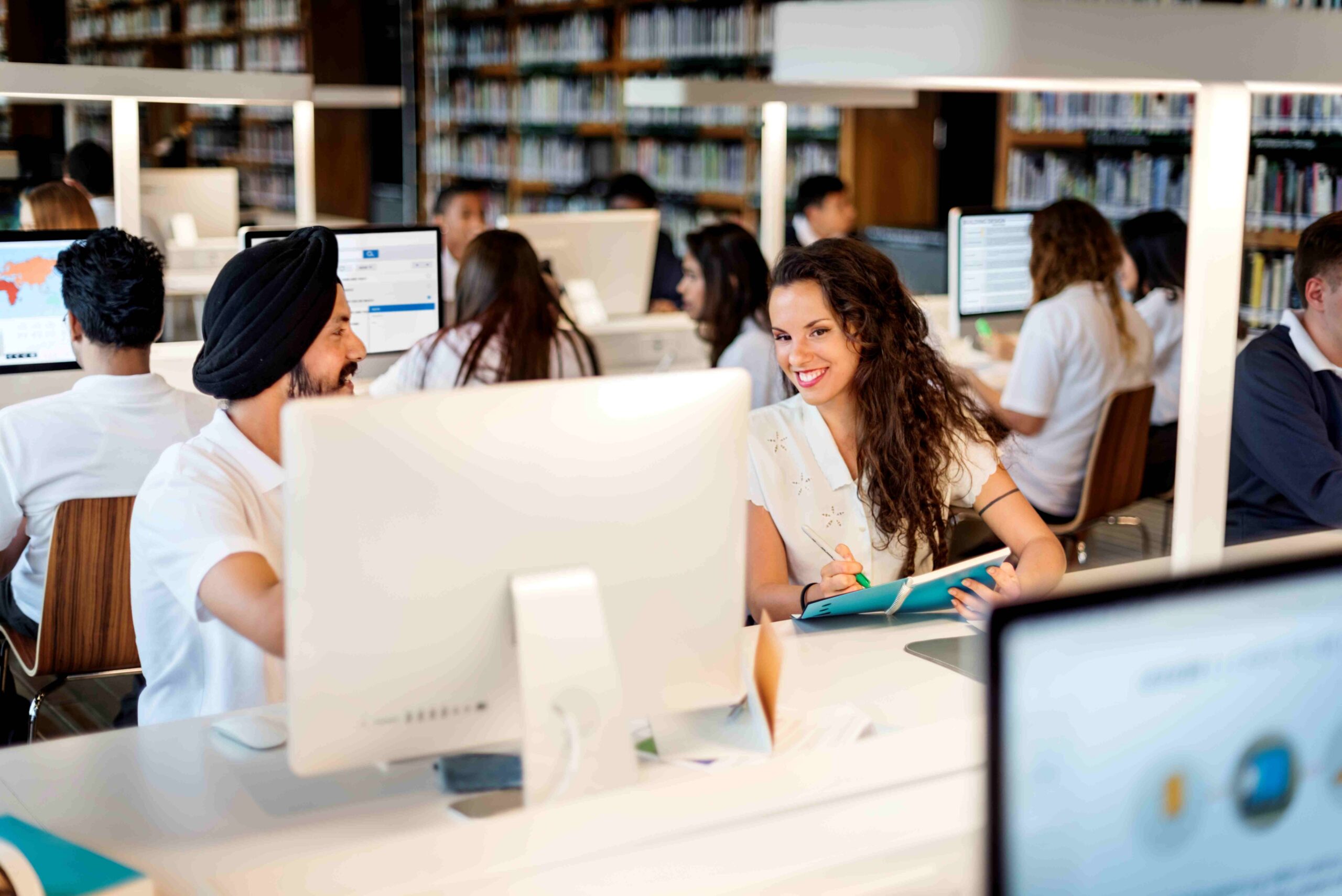 Smiling young adults working at computers in libra 2026 01 07 23 44 03 utc scaled 1
