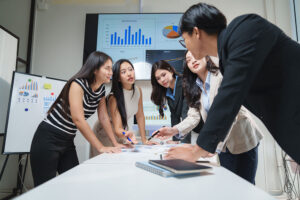 Team analyzing business charts and reports during a strategy meeting