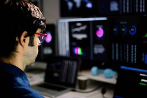 Man at computer looking at Cloud monitoring and observability