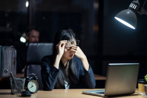 Employee working late, highlighting the need for an AI Governance Accelerator