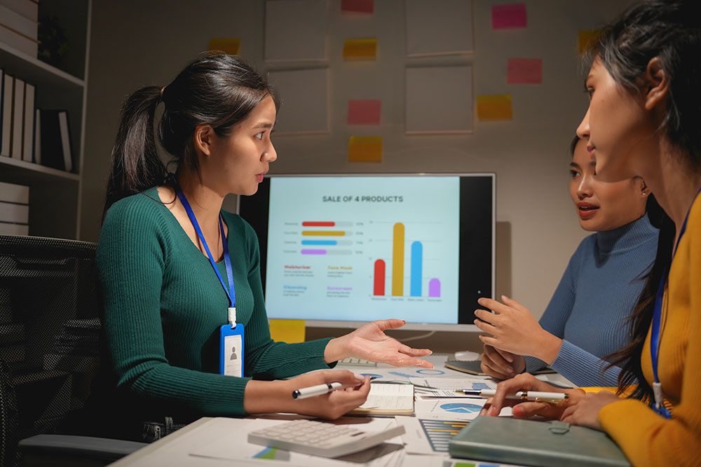Team discussing performance metrics on a data chart during a meeting