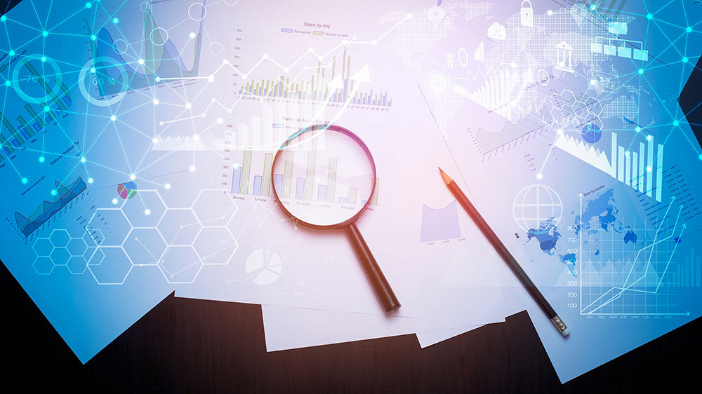 Magnifying glass examining reports with digital data visualization overlay