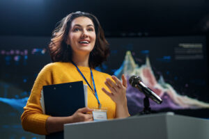 Confident presenter discussing data trends at an industry conference event