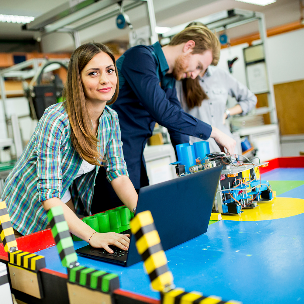 Engineers developing autonomous AI agents and agentic AI framework in robotics lab