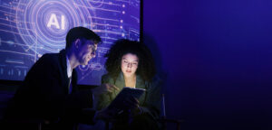 People discussing AI technology with a digital tablet in a dark tech environment