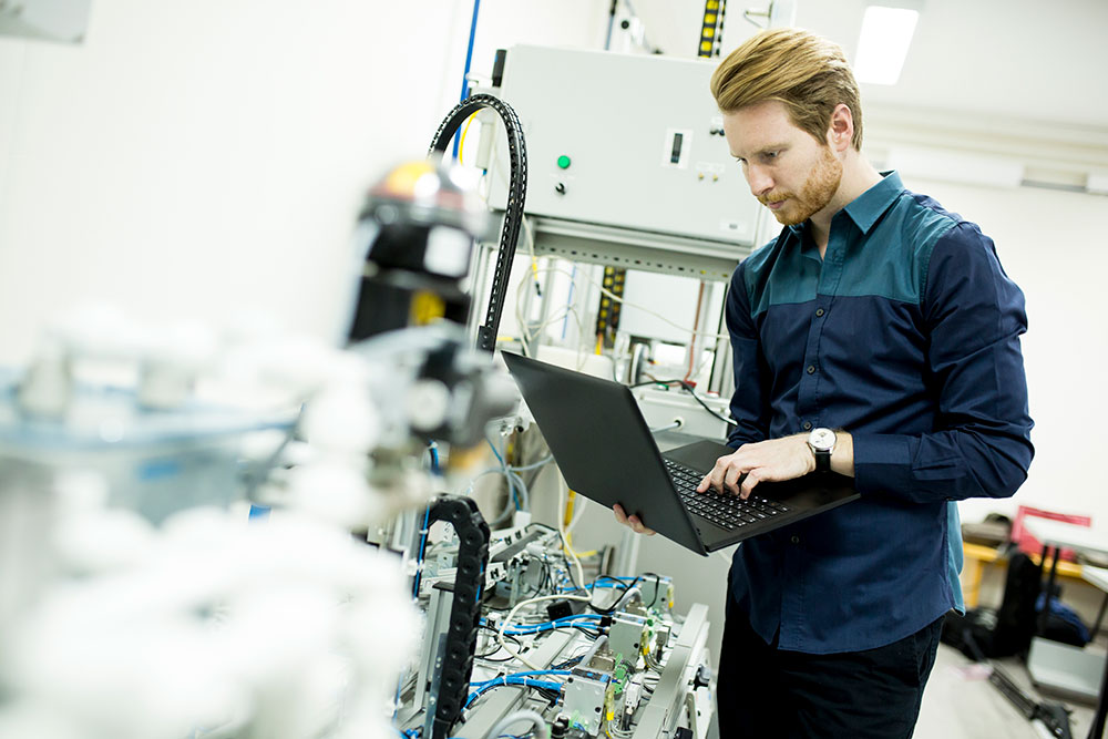 Person programming robotic equipment for Industrial Automation