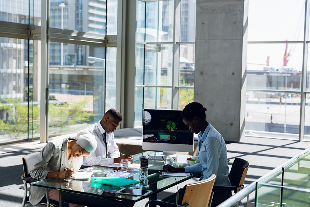 Diverse team collaborating on AI governance and responsible AI assurance strategies