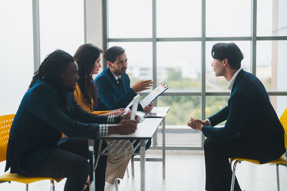 Panel interviewing a candidate in a modern office for Talent Recruitment