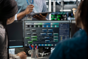 Team monitoring AI agent orchestration and multi-agent workflow automation on control room screens