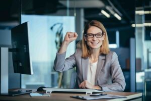 Cheerful woman celebrates success in office worksp 2026 01 09 08 09 55 utc scaled