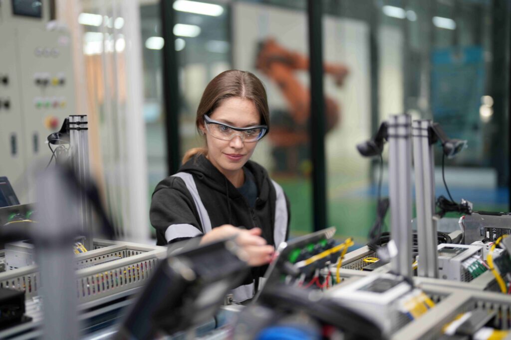 Technician assembling electronic components on a production line
