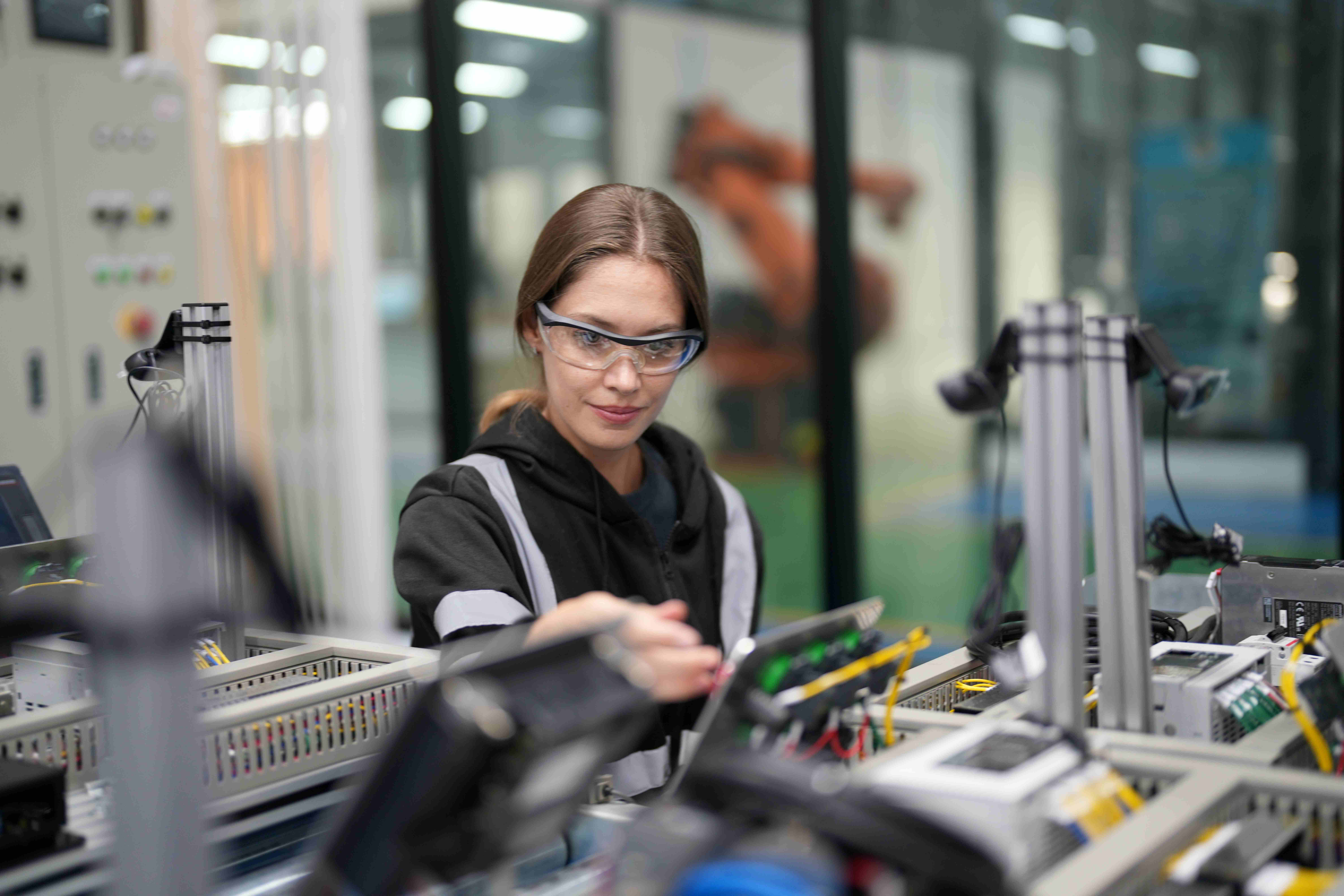 Technician assembling electronic components on a production line