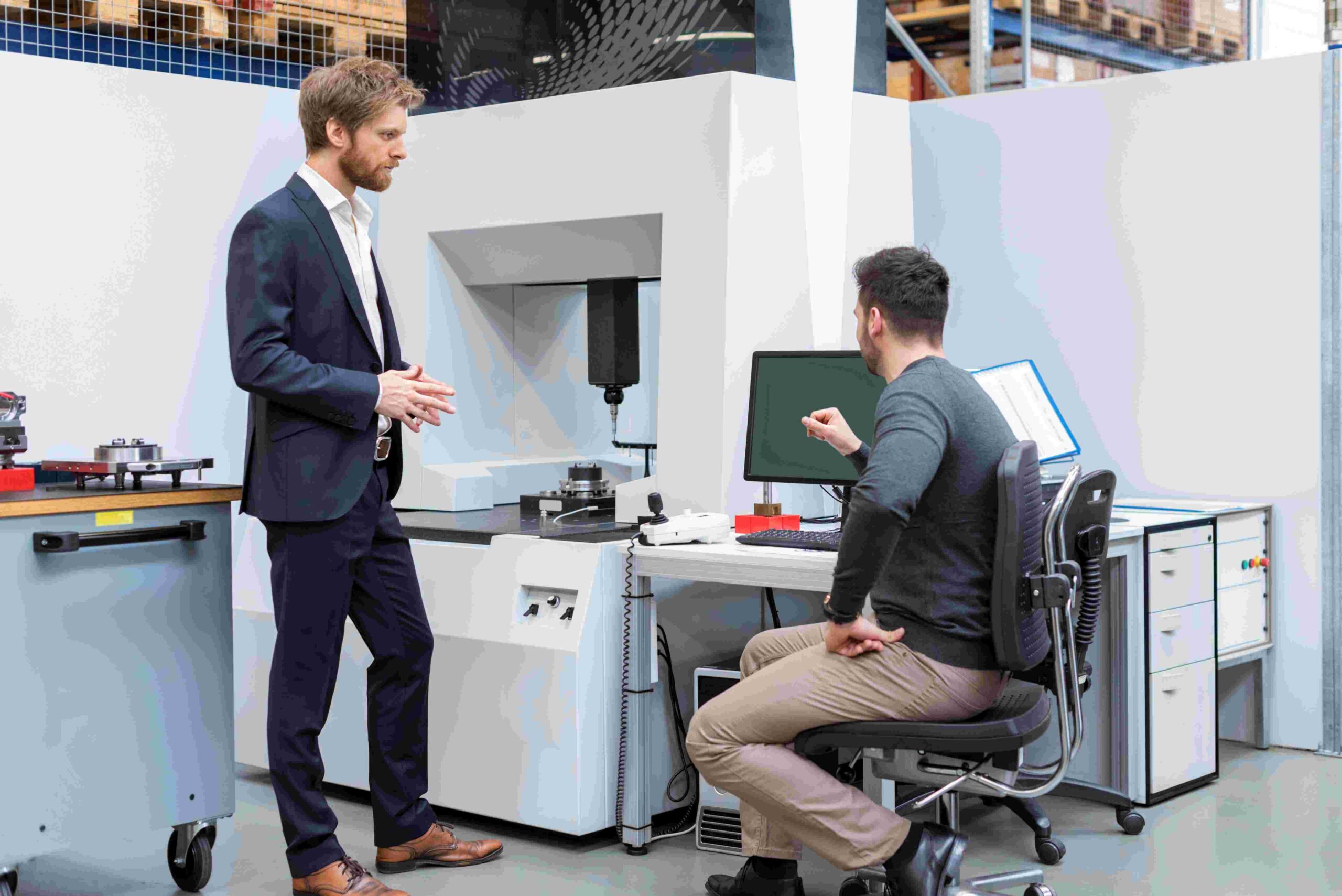 People discussing Veloce testing equipment in facility