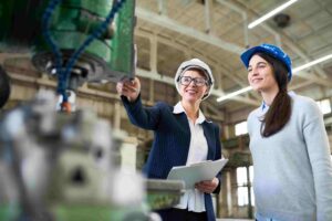 Engineers reviewing data on factory floor