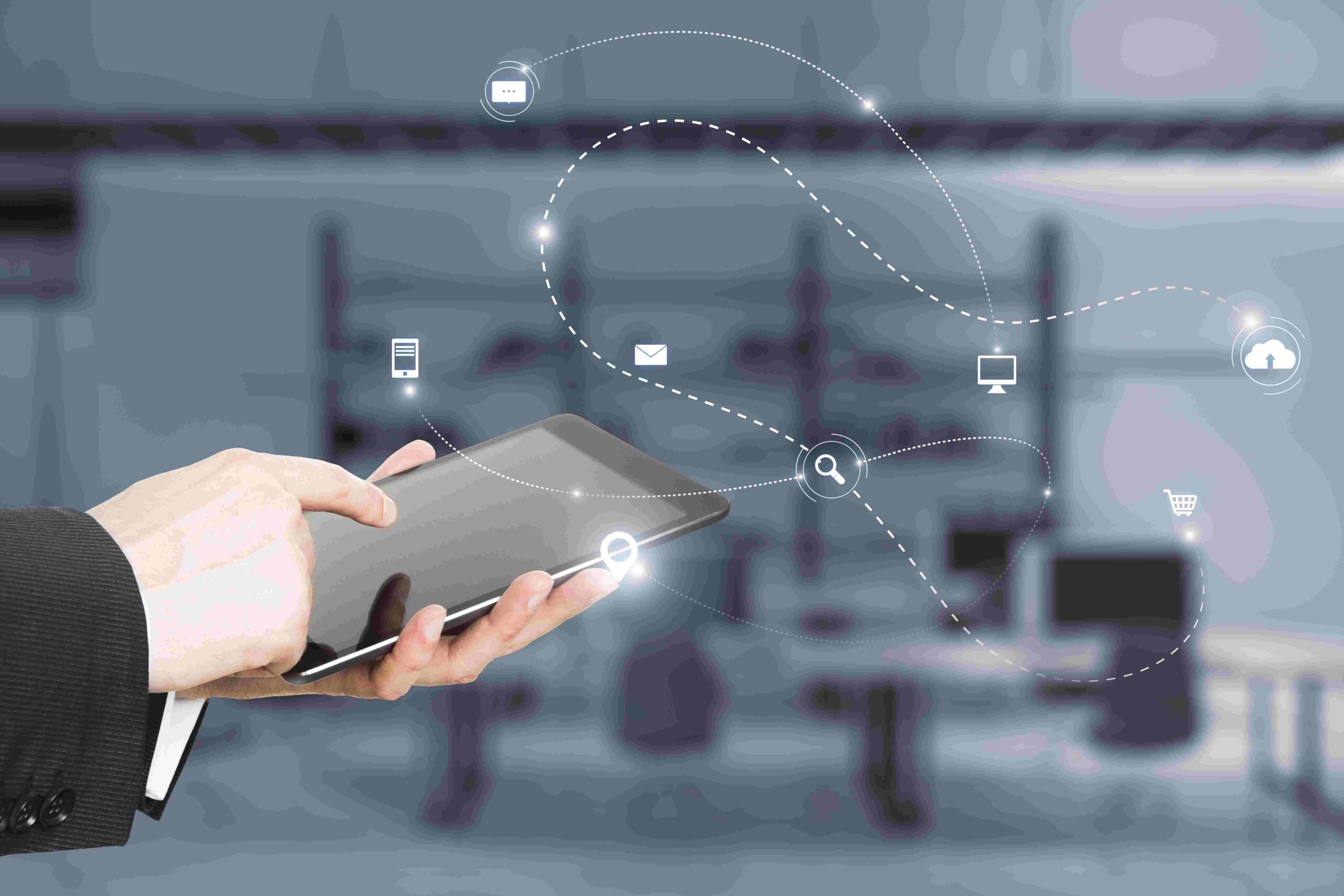 Digital icons flowing from a handheld tablet