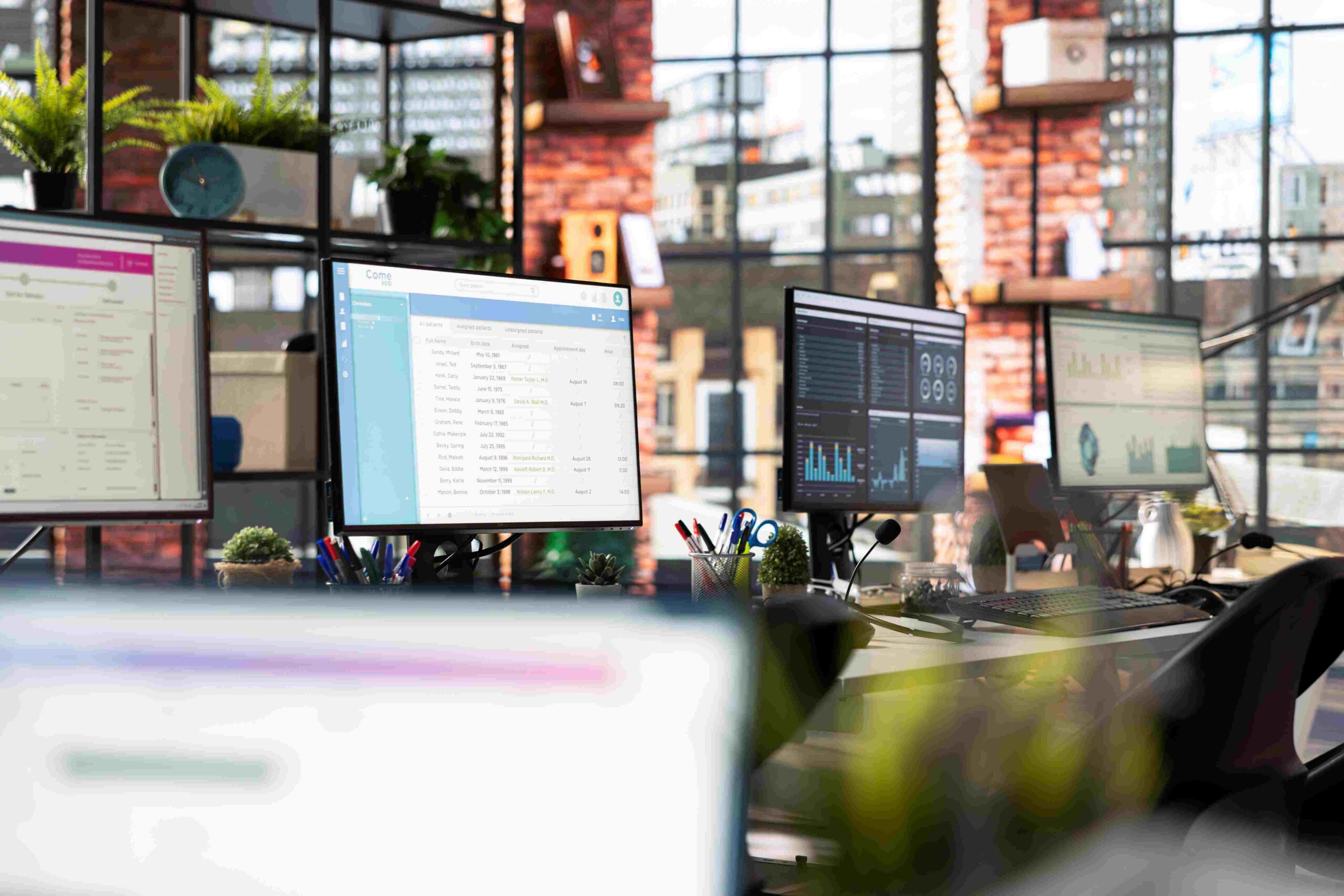 Multiple desktop screens showing analytics in bright workspace