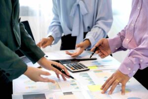 People analyzing Enterprise QA services reports together